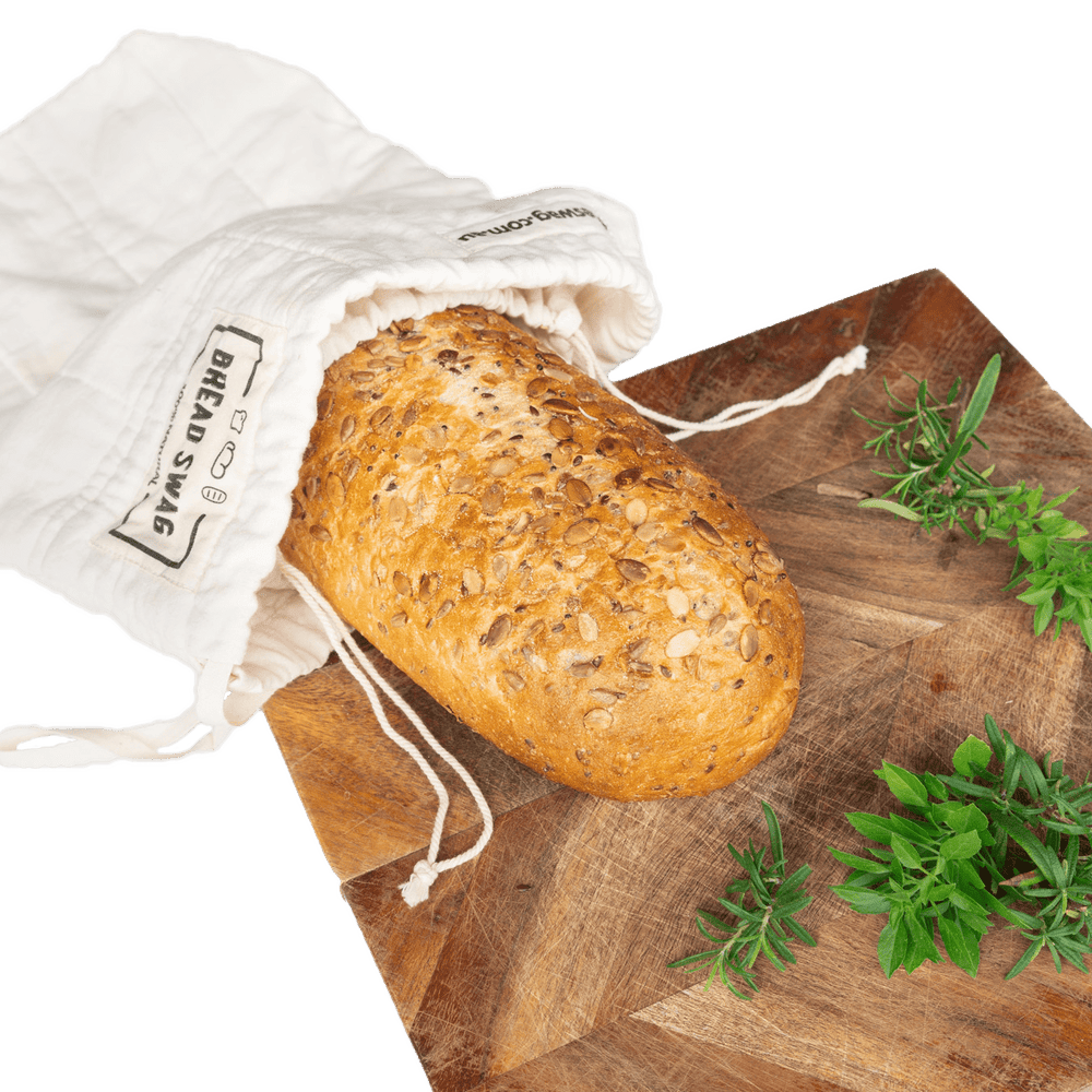 
                      
                        The Swag reusable Bread bag on a bread board with sourdough bread inside the bag - The Swag AU
                      
                    