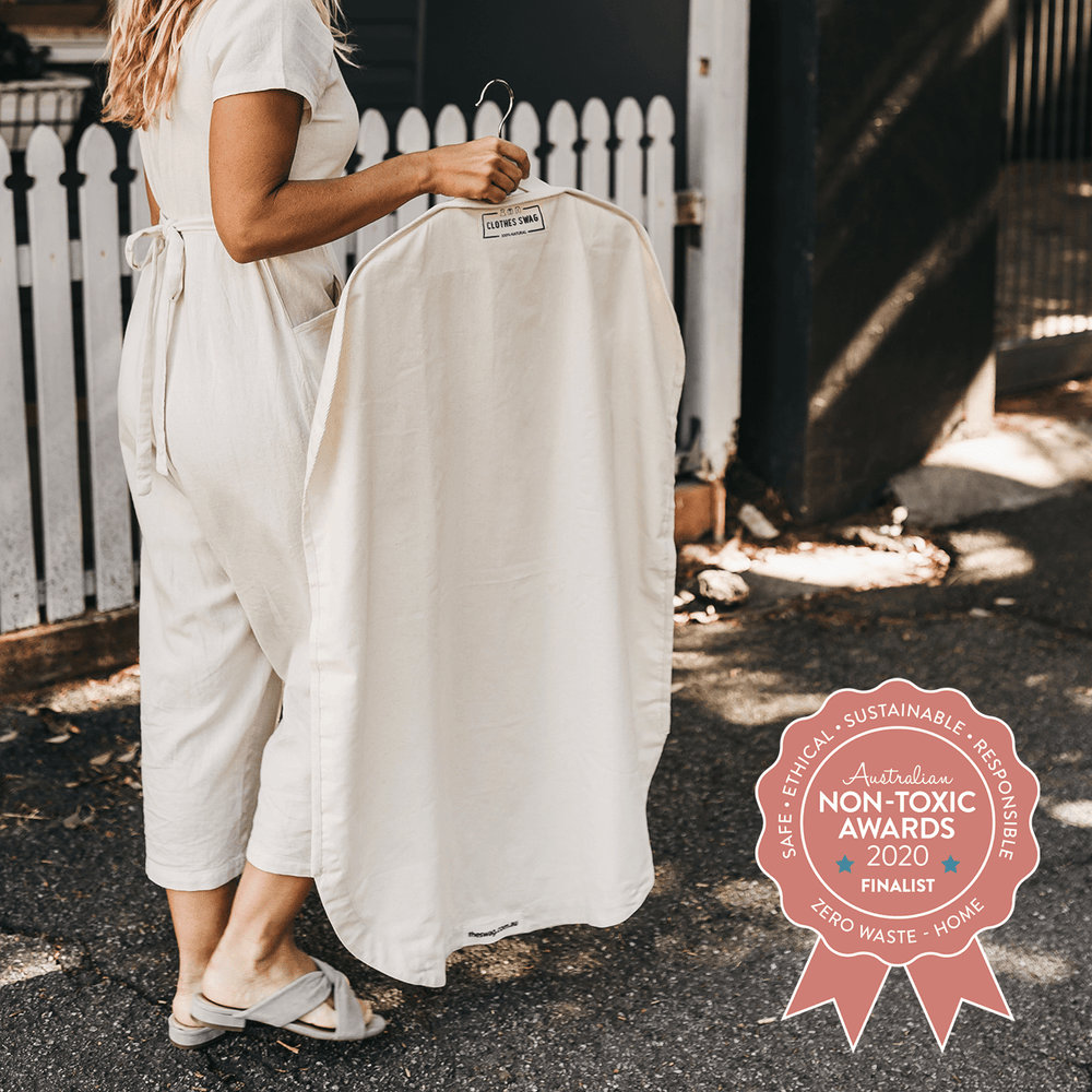 
                      
                        The Swag - a woman carrying reusable The Clothes Swag filled with clothing on a hanger. plus, featuring the non-Toxic Awards finalist badge - The Swag AU
                      
                    