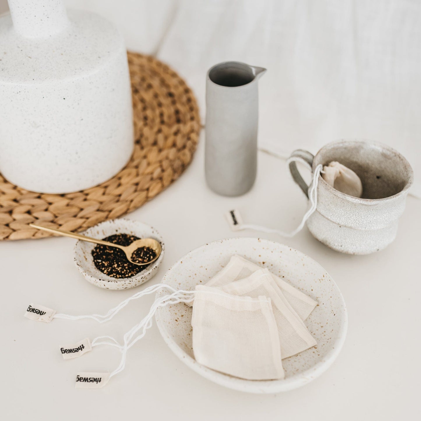 The Swag reusable Tea Swag set with a cup of tea and one tea Swag dangling out of the cup - The Swag AU