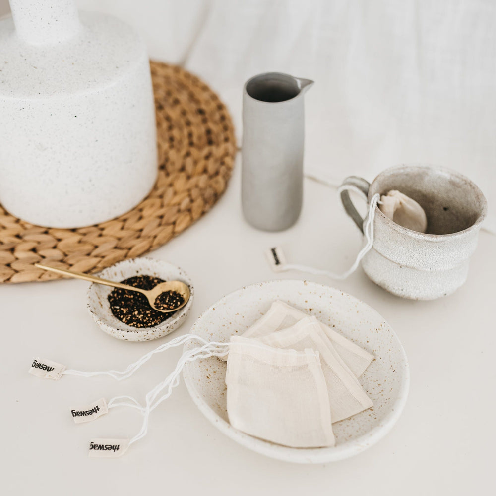 
                      
                        The Swag reusable Tea Swag set with a cup of tea and one tea Swag dangling out of the cup - The Swag AU
                      
                    
