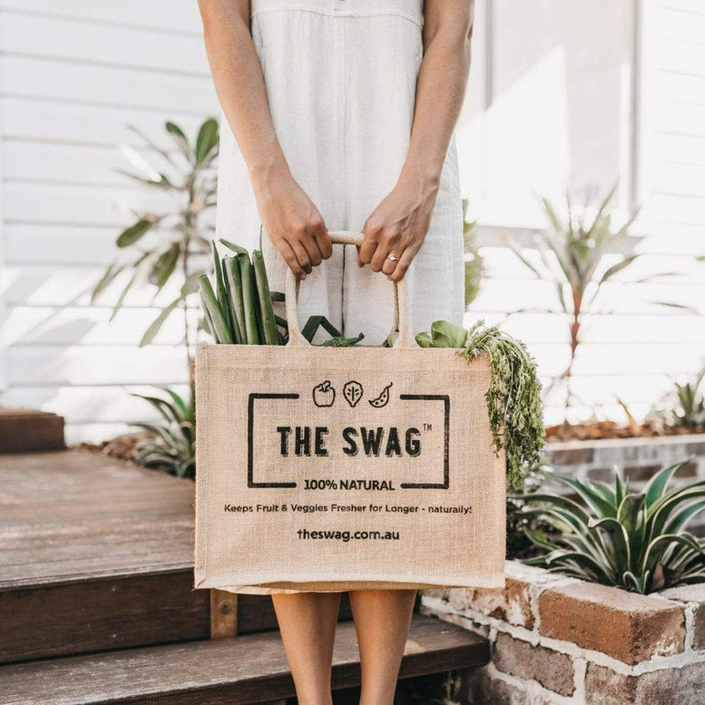 
                      
                        Woman holding The Swag reusable and 100% natural carry bags made from hessian and filled with fresh fruit and veggies - The Swag AU

                      
                    